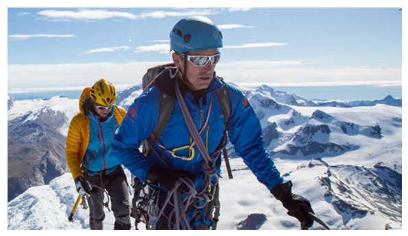 Kenton Cool and Sam Branson wearing climbing gear in snowy mountainous conditions