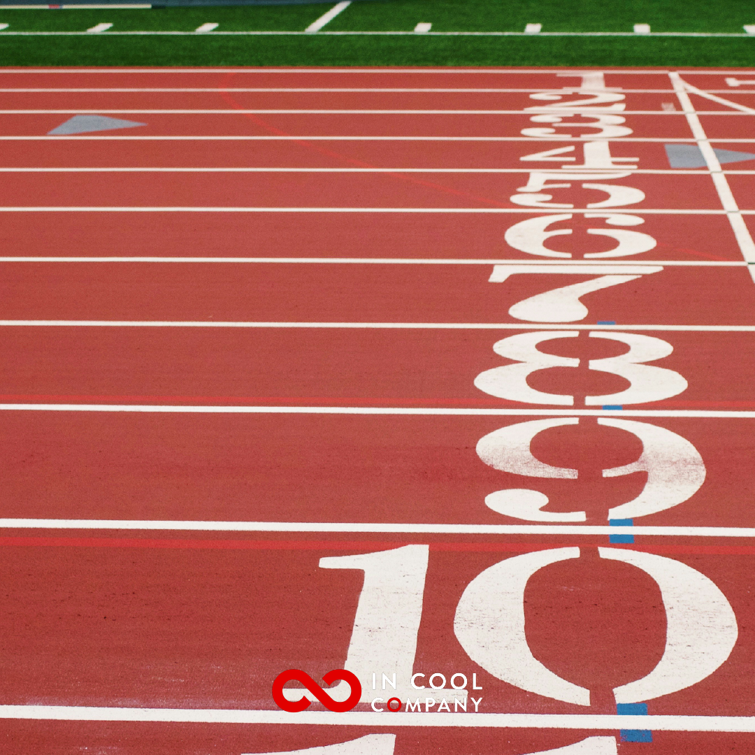 A close up of a running track with the lane numbers the main focus of the image