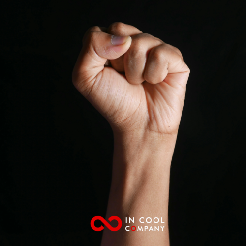 A fist is clenched and held up in a celebratory gesture