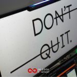 A computer screen with the words Don't Quit in large letters, with the 'NT' of Don't and the 'QU' of Quit crossed out