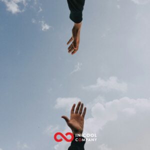 Two hands shown a little way apart, trying to touch