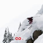A skier skis off piste down a steep slope