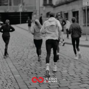 Runners moving down a cobbled street