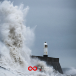 Sea waves crashing over a lighthouse