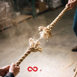 A rope is being pulled by a person at either end and is about to break in the middle