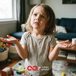 A small child looking puzzled with his hands out asking a question